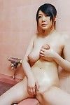 Bosomy babe Rie Tachikawa is rubbing her big melons and masturbating nub with shower