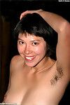 Smiling Asian babe Amanda gets outdoors and reveals hairy parts of body