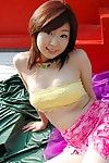 Juicy boobed Asian teen chick Yuu Idols is bending in hot poses on the bed and excitingly showing her pussy