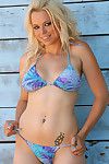 Young blonde likes to pose in her bikini and gently taking them down during solo