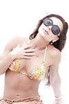 Mature woman Nina Dolci letting firm tits free from bikini on beach