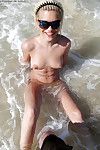 Naked amateur teenage babes in sunglasses having some fun on the beach