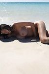 Undressed enormous breasted Japanese Tera Patrick shows off her sexiest body in sand on the beach